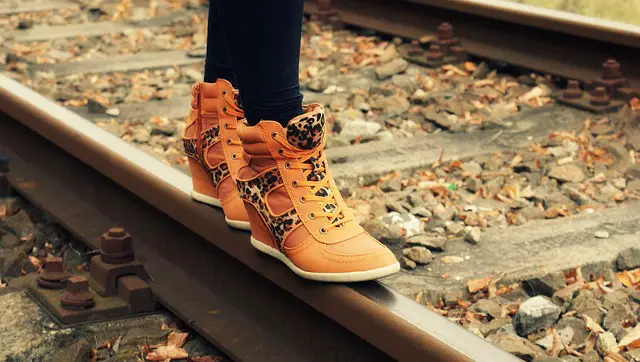 girl boots balancing on railroad