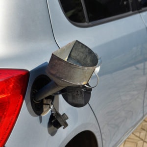 pouring fuel into the car gas tank